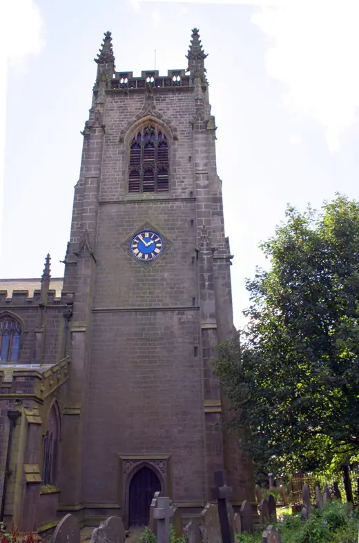The ruined tower of the old church at Heptonstall rising above a crowded graveyard.