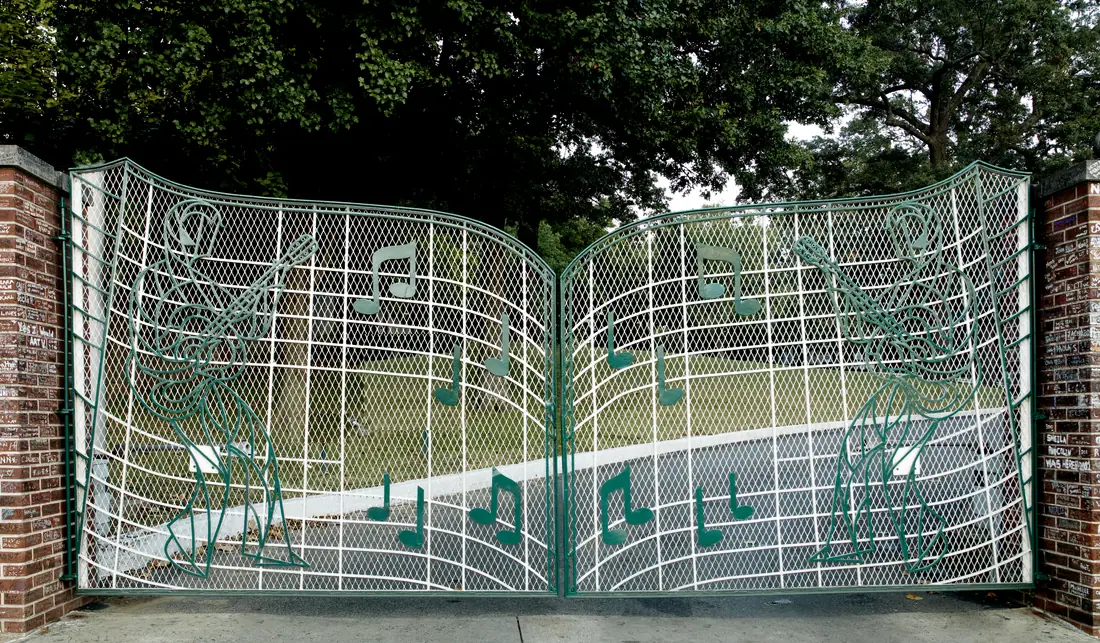 The wrought-iron music-note gates at the entrance to Graceland on Elvis Presley Boulevard, Memphis.