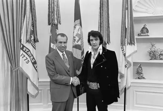 Elvis Presley shaking hands with President Richard Nixon in the Oval Office.