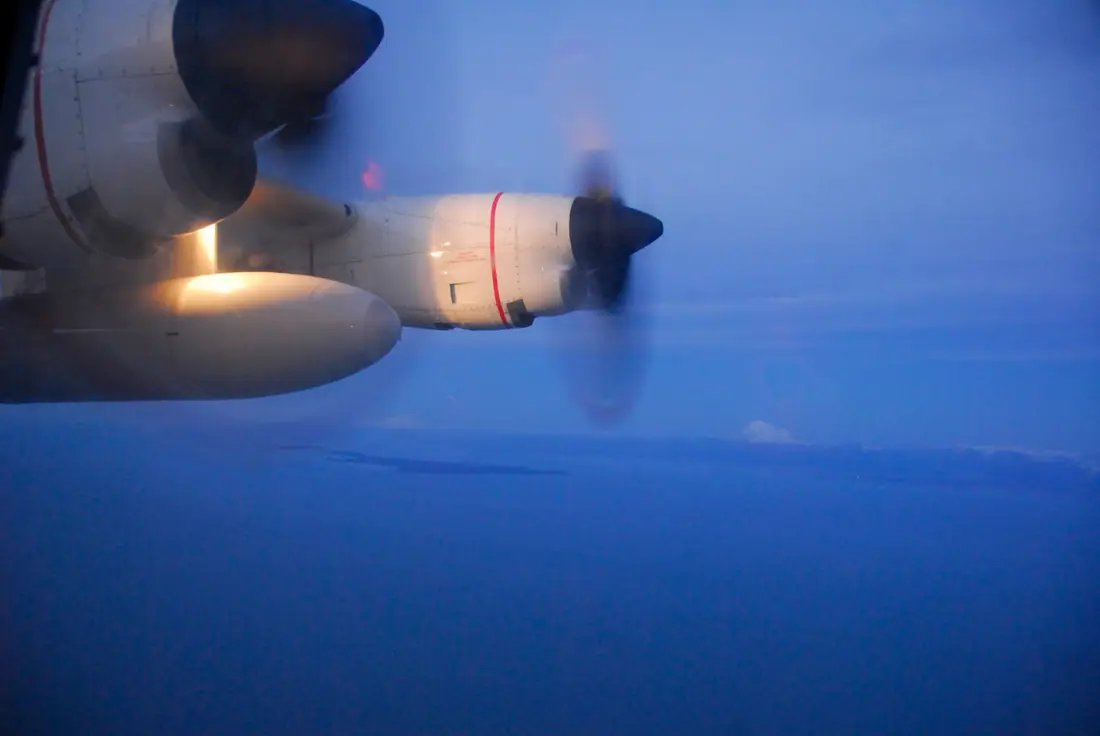 A Coast Guard HC-130 Hercules aircraft in flight on a first-light search and rescue mission over Cook Inlet, Alaska.