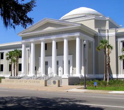 The front facade of the Florida Supreme Court Building in Tallahassee under a clear sky.