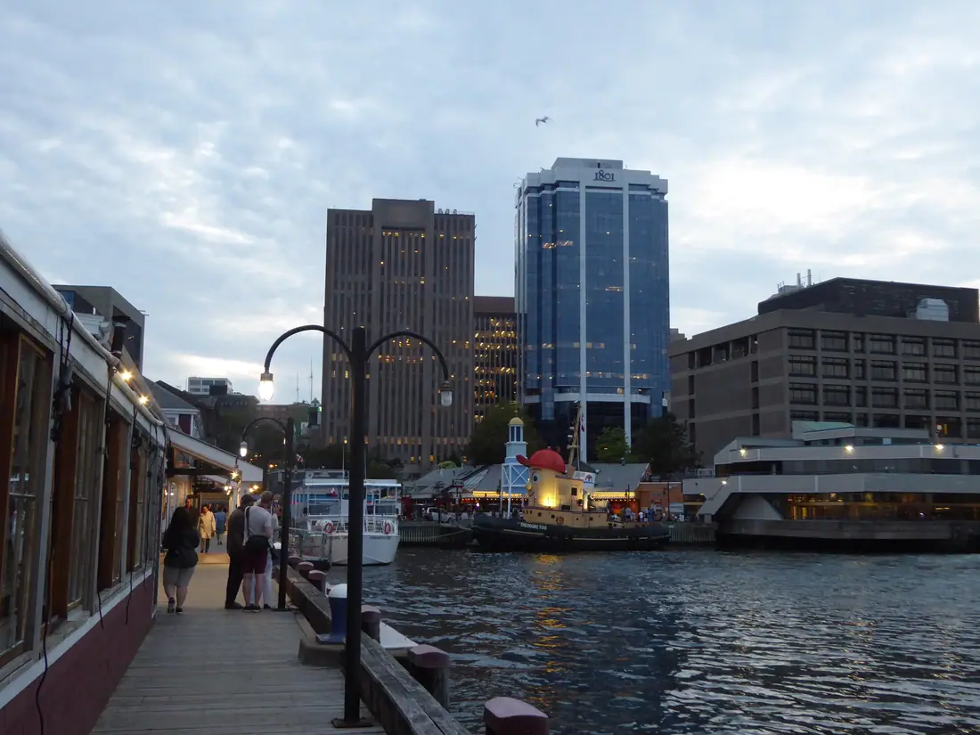 Downtown Halifax, Nova Scotia at twilight, seen across the water from a waterfront pier.