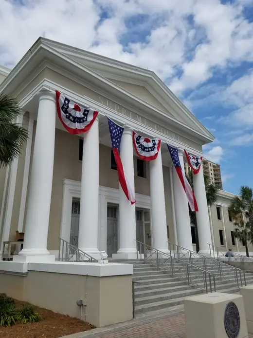Side view of the Florida Supreme Court building in Tallahassee draped with bunting.