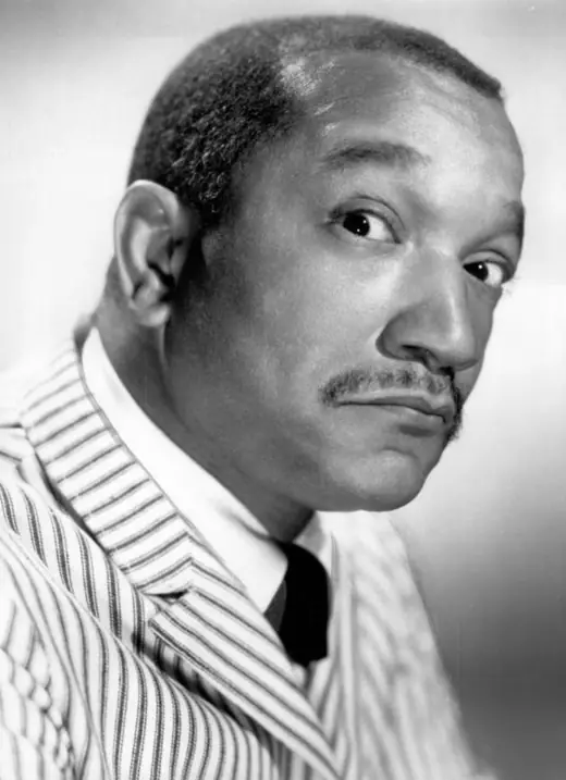 Publicity portrait of a stand-up comedian in a suit, 1966.