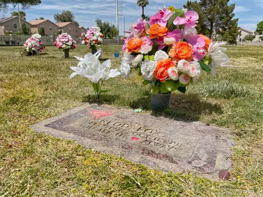 A flat granite grave marker set in grass at a Las Vegas cemetery.