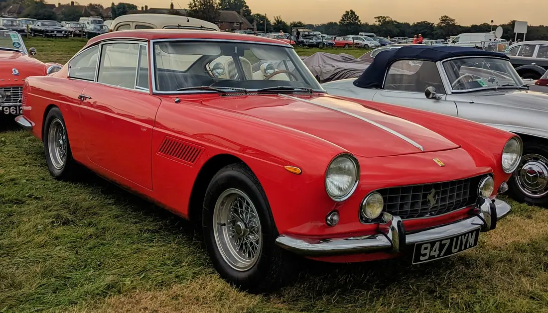 A Ferrari 330 America two-plus-two coupe in profile at a car show.