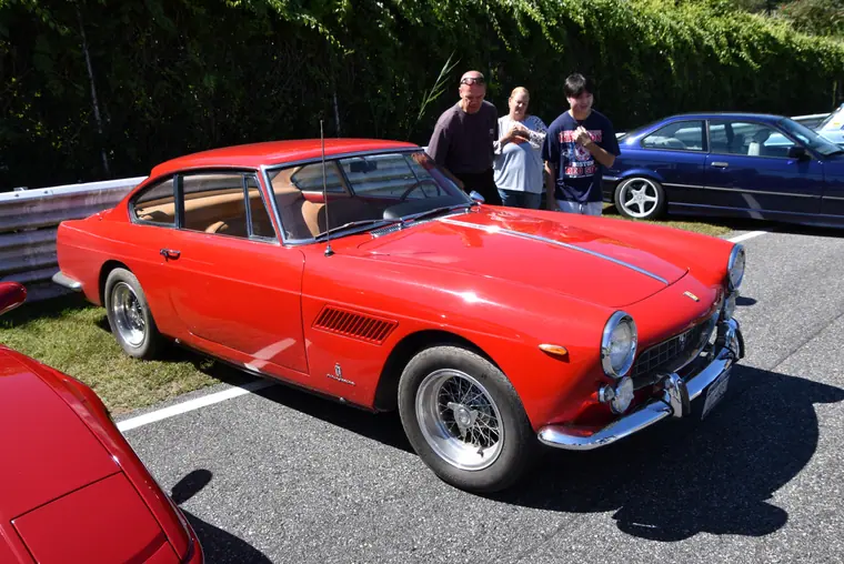 A 1964 Ferrari 330 America coupe photographed in three-quarter front view.