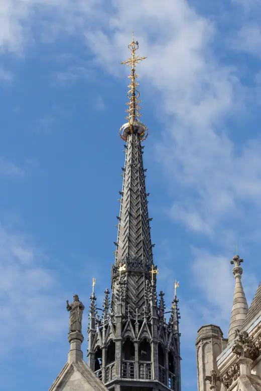 A spire of the Royal Courts of Justice in London against the sky.