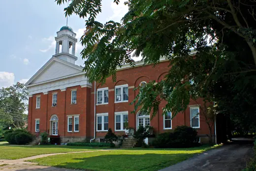 The old Mahoning County Courthouse in Canfield, Ohio, a white nineteenth-century civic building with a cupola.