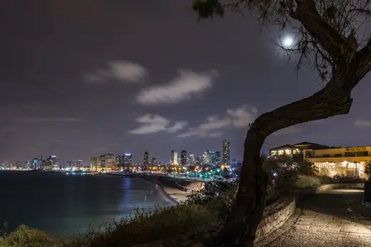 The Tel Aviv skyline seen across the city, with high-rise towers along the Mediterranean coast.