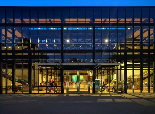 The long brick Steve Jobs Building at the Pixar campus in Emeryville, photographed at dusk.