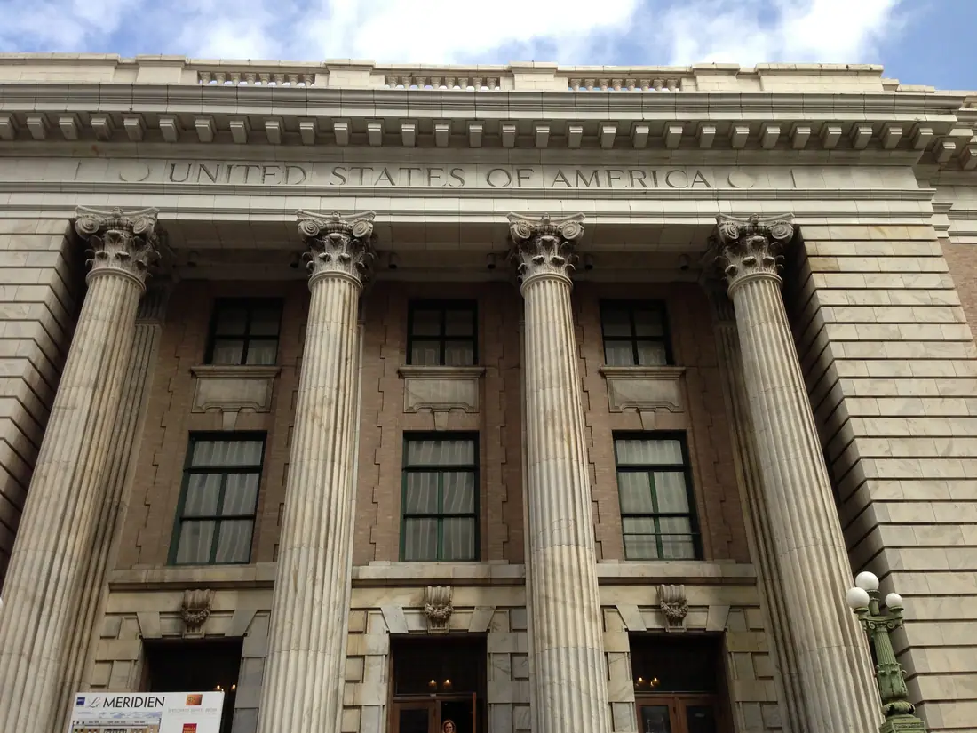 The full exterior of Tampa's classical federal courthouse seen from the street.