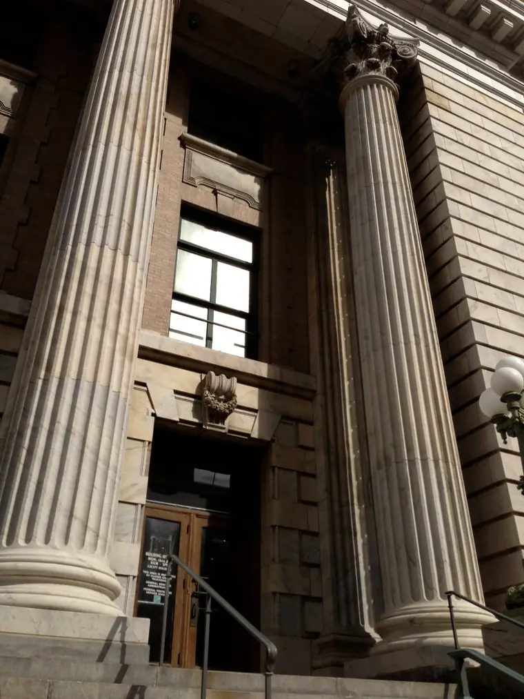 The neoclassical stone entrance of the old federal courthouse in Tampa, framed by columns.