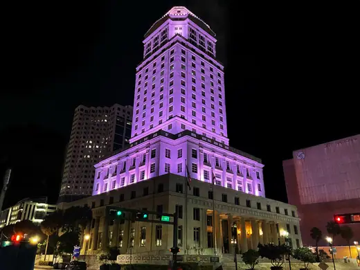 The Miami-Dade Flagler Street courthouse building seen from the street on a clear day.