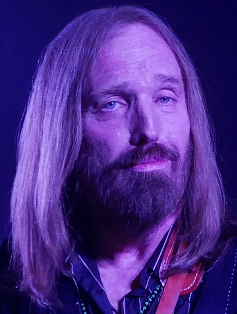 Tom Petty singing at a microphone with a guitar, performing with Mudcrutch at The Fillmore in San Francisco, June 2016.