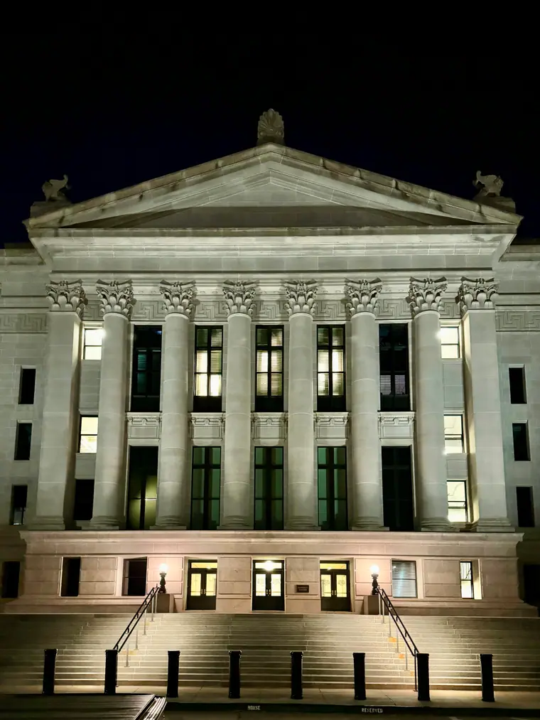 The Oklahoma State Capitol in Oklahoma City, a domed neoclassical building photographed from ground level against a clear sky.